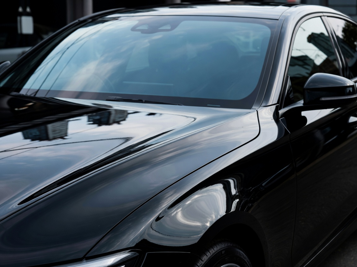 Super high gloss reflection on black premium car panels after paint sealant treatment